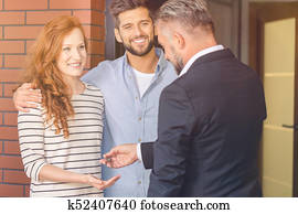 Couple taking keys of apartment