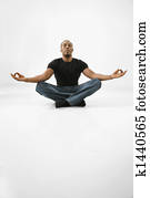 Man sitting meditating.