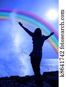 silhouette of a lone woman raising her arms in awe and praise at the power of nature silhouette of a lone woman raising her arms in awe and praise at the power of nature