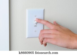 Woman turning off light switch