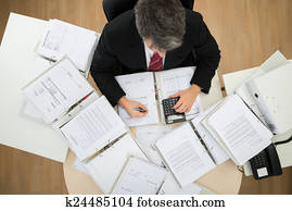 Businessman Calculating Bills