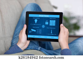 man holding tablet with program smart home on the screen