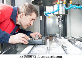 worker operating CNC machine center worker operating CNC machine center