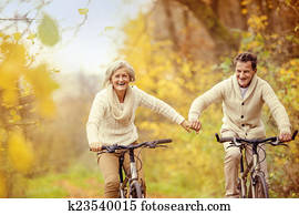 Active seniors riding bike