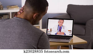Black patient discussing health problems with doctor online