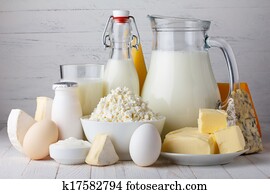 Dairy products, milk, cottage cheese, eggs, yogurt, sour cream and butter on wooden table Dairy products, milk, cottage cheese, eggs, yogurt, sour cream and butter on wooden table