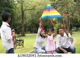indian family playing kite in the outdoor park indian family playing kite in the outdoor park