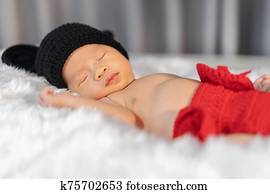 newborn baby in mouse costume sleeping on fur bed newborn baby in mouse costume sleeping on fur bed