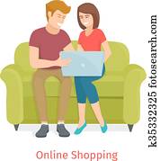 Laughing couple browsing the internet at the laptop