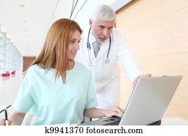 Doctor and intern working in hospital