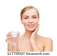 woman applying cream on her skin woman applying cream on her skin