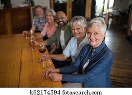 Happy friends having drinks in bar
