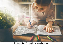 Child paint a coloring book