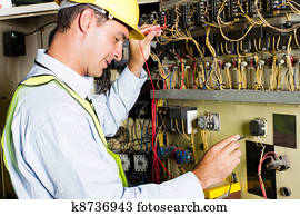 electrician testing industrial machine