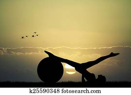 Pilates silhouette at sunset Pilates silhouette at sunset