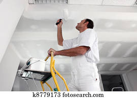 Tradesman painting a ceiling Tradesman painting a ceiling