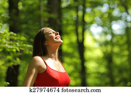 Woman breathing fresh air in the forest