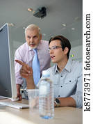 Young businessmen explaining point to boss