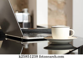 Laptop on a table workplace with a cup of coffee