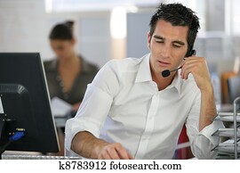 Young man telemarketer in call center Young man telemarketer in call center