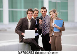 Business team stood outside office block