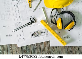 Construction plans with helmet and drawing tools on blueprints . Construction plans with helmet and drawing tools on blueprints .