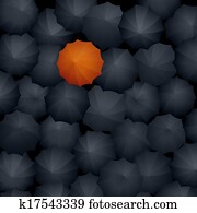Many black umbrellas, one orange.
