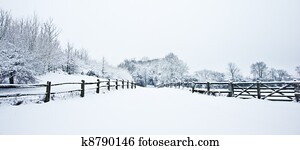 Path through English rurual countryside in Winter with snow