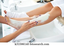 Aplying nourishing moisturizer mask woman legs Aplying nourishing moisturizer mask woman legs