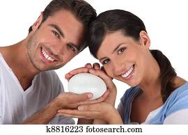 Couple holding bar of soap