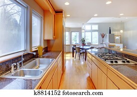 Large luxury modern wood kitchen with granite counter tops.