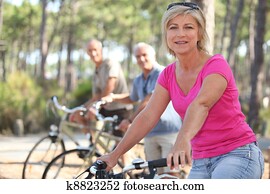 group of seniors riding bikes in the park