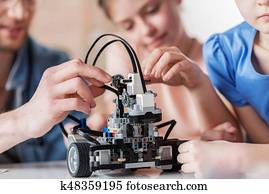 Interested persons working together on robotics Interested persons working together on robotics