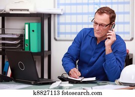 Mechanic on phone in office Mechanic on phone in office