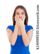 No more word. Shocked young woman covering mouth with hands while standing isolated on white