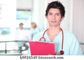 Young medic in hospital scrubs with clipboard