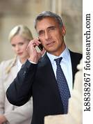 Businessman talking on cellphone outdoors
