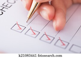 Businesswoman Writing On Checklist Businesswoman Writing On Checklist