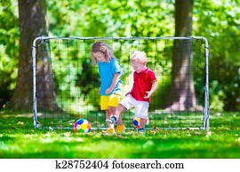 Children playing football outdoors
