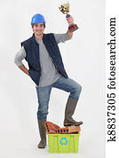 Tradesman holding up a trophy
