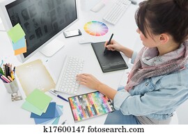 Artist drawing something on graphic tablet at office