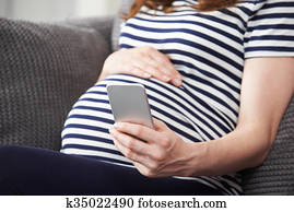 Close Up Of Woman Texting On Mobile Phone
