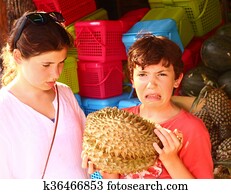 teenage girl and boy smell durian