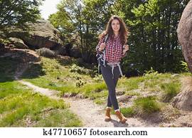 Woman hiking in summer forest in mountains Woman hiking in summer forest in mountains