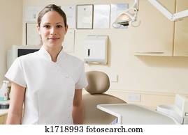 Dental assistant in exam room smiling