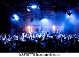 People dancing at the concert, anonymous girls on the stage People dancing at the concert, anonymous girls on the stage