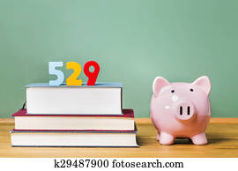 529 college savings plan theme with textbooks and piggy bank