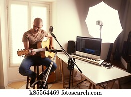 guitar player recording at home studio
