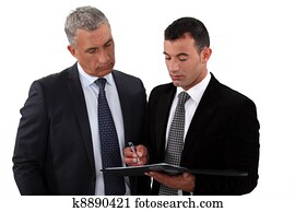 Businessmen looking at a clipboard