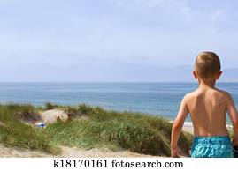 Boy overlooking the North Sea coastline